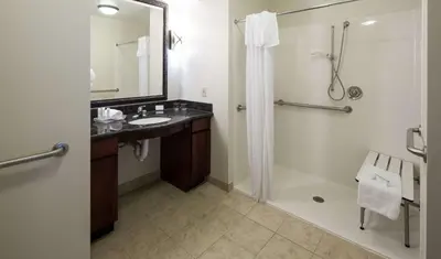 a bathroom with a shower and a sink and a shower at Homewood Suites by Hilton Agoura Hills in Agoura Hills