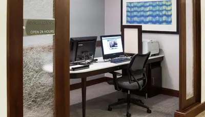 an office with a desk with a computer and a monitor at Homewood Suites by Hilton Agoura Hills in Agoura Hills