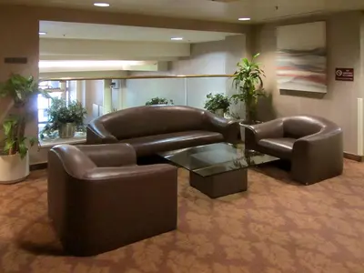 a leather couch and two chairs in a lobby at Kawada Hotel in Los Angeles