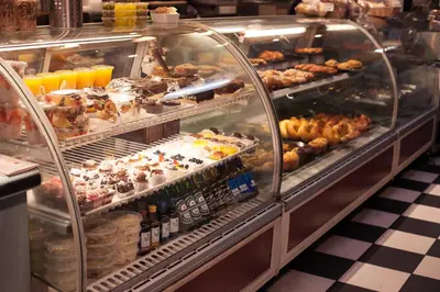 a display case filled with lots of different pastries at Kawada Hotel in Los Angeles