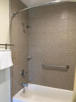 a bathroom with a shower and a sink at Simply Home Inn & Suites - Riverside in Riverside