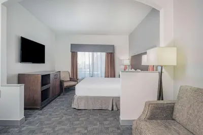 a hotel room with a bed and a tv at Ramada by Wyndham Bakersfield in Bakersfield