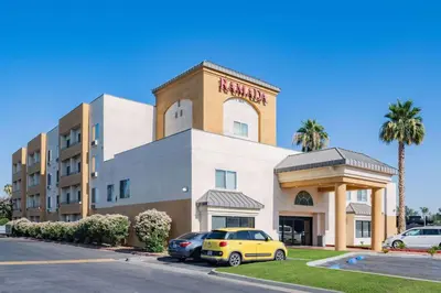 a hotel with cars parked in front of it at Ramada by Wyndham Bakersfield in Bakersfield