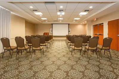 a conference room with chairs and a white screen at Hilton Garden Inn Bakersfield in Bakersfield