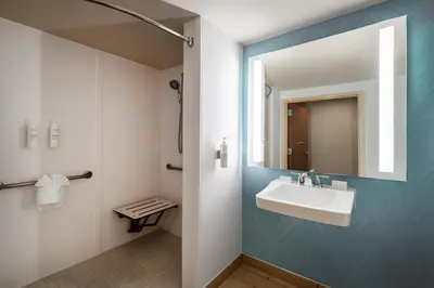 a bathroom with a sink and a mirror at Hilton Garden Inn Bakersfield in Bakersfield