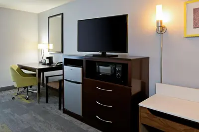 a hotel room with a television on top of a dresser at Hampton Inn and Suites Bakersfield / Highway 58 in Bakersfield