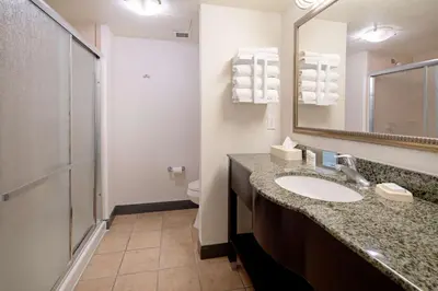 a bathroom with a sink and a mirror and a toilet at Hampton Inn and Suites Bakersfield / Highway 58 in Bakersfield