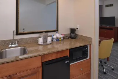 a kitchen counter with a sink and a dishwasher at Hampton Inn and Suites Bakersfield North-Airport in Bakersfield