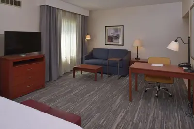 a hotel room with a bed and a desk and a television at Hampton Inn and Suites Bakersfield North-Airport in Bakersfield