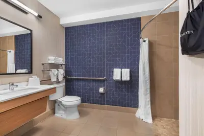 a bathroom with a toilet and a sink and a shower at Spark by Hilton Bakersfield Central in Bakersfield