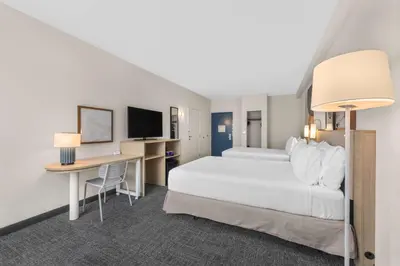 a hotel room with a bed and a desk at Spark by Hilton Bakersfield Central in Bakersfield