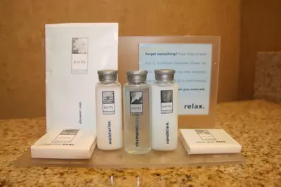 three bottles of water sitting on a counter next to a box at Hampton Inn and Suites Barstow in Barstow