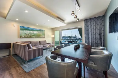 a living room with a couch and a table and chairs at Shade Hotel Redondo Beach in Redondo Beach