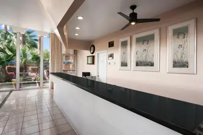 a lobby of a hotel with a reception counter at Travelodge by Wyndham Bakersfield in Bakersfield