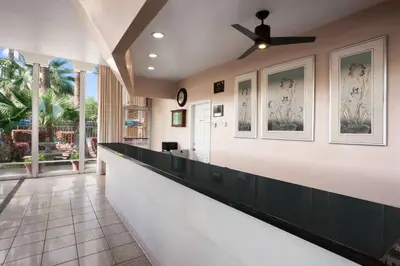 a lobby with a bar with a ceiling fan at Travelodge by Wyndham Bakersfield in Bakersfield