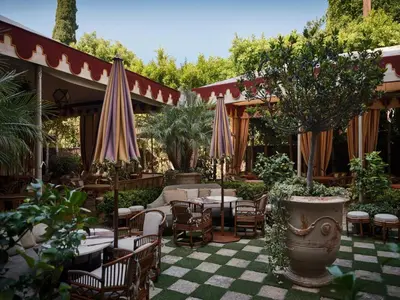 a patio with tables and chairs and umbrellas at Chateau Marmont in Los Angeles