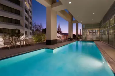 a swimming pool in the middle of a building at Embassy Suites Los Angeles Glendale in Glendale