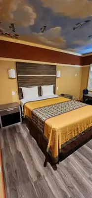 a hotel room with a large bed in a room at Geneva Motel in Inglewood