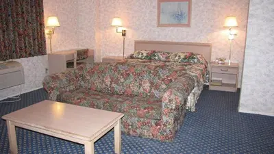 a hotel room with a bed and a couch at Nisei Inn in Gardena