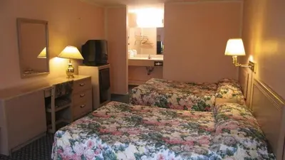 a hotel room with two beds and a sink at Nisei Inn in Gardena