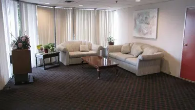 a living room with a couch and a coffee table at Nisei Inn in Gardena