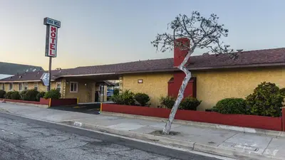 a building with a tree in front of it at Casa Bell Motel, Los Angeles - LAX Airport in Inglewood