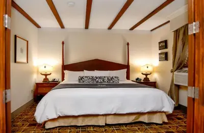 a bedroom with a large bed and two lamps at Brand Plaza Hotel in Glendale