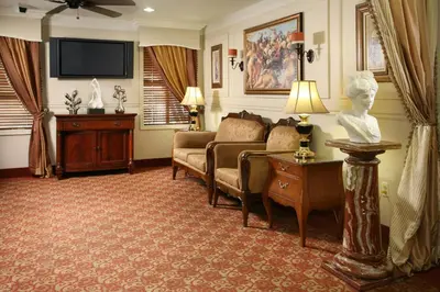 a living room with a couch and a tv at Brand Plaza Hotel in Glendale