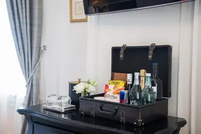 a black suitcase sitting on top of a table at The Culver Hotel in Los Angeles