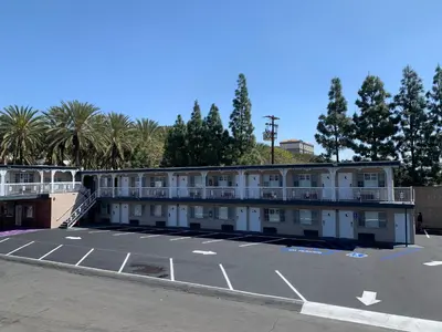 an empty parking lot in front of a hotel at Riviera Motel in Anaheim
