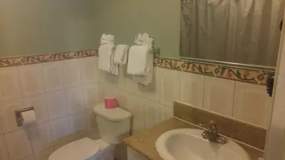a bathroom with a toilet and a sink at Riviera Motel in Anaheim