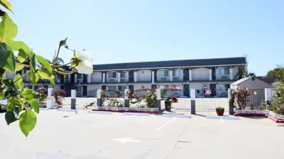 an empty courtyard in front of a building at Value Inn Bellflower in Bellflower