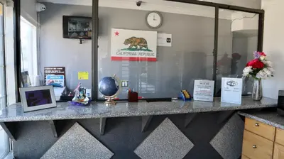 an office with a counter with a bear on the wall at Value Inn Bellflower in Bellflower