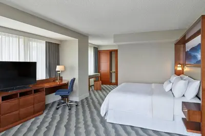 a hotel room with a bed and a flat screen tv at The Westin Pasadena in Pasadena