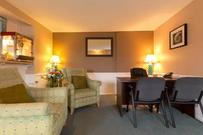 a hotel room with a desk and chairs and a table at Channel Island Shores in Oxnard