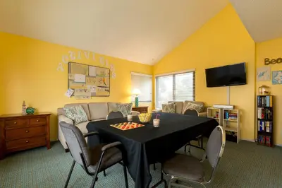 a living room with a table and a couch at Channel Island Shores in Oxnard