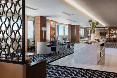 a lobby of a hotel with tables and chairs at The Ritz-Carlton, Los Angeles L.A. Live in Los Angeles