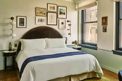 a bedroom with a large bed and some windows at Hotel Per La, Autograph Collection in Los Angeles
