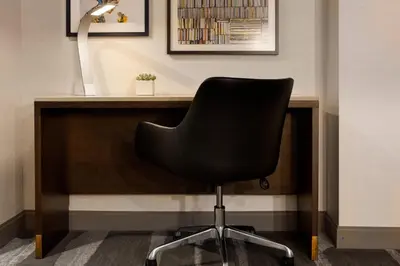 a black chair sitting in front of a desk at Renaissance Los Angeles Airport Hotel in Los Angeles