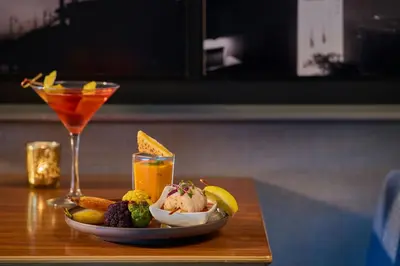 a plate of food on a table with a drink at Renaissance Los Angeles Airport Hotel in Los Angeles
