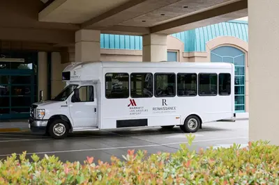 a white bus parked in front of a building at Renaissance Los Angeles Airport Hotel in Los Angeles