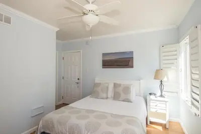 a white bedroom with a bed and a ceiling fan at Venice on the Beach Hotel in Los Angeles