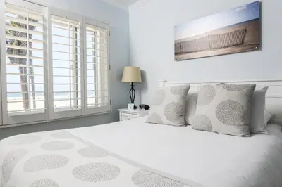 a bedroom with a white bed with white pillows at Venice on the Beach Hotel in Los Angeles