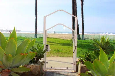 an open door leading to the beach with plants at Venice on the Beach Hotel in Los Angeles