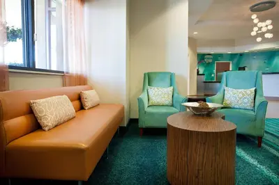 a waiting room with a couch and two chairs at SpringHill Suites Los Angeles LAX/Manhattan Beach in Hawthorne