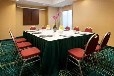 a conference room with a large table and chairs at SpringHill Suites Los Angeles LAX/Manhattan Beach in Hawthorne