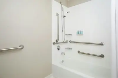 a bathroom with a shower and a bath tub at SpringHill Suites Los Angeles LAX/Manhattan Beach in Hawthorne