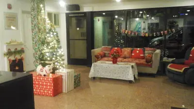 a living room with a christmas tree and a couch at 777 Motor Inn in Huntington Beach