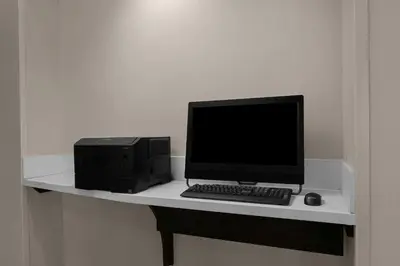 a desk with a computer monitor and a keyboard and mouse at Residence Inn Los Angeles Burbank/Downtown in Burbank