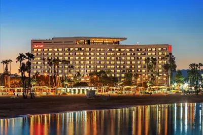 a large building on the beach with palm trees at Marina del Rey Marriott in Los Angeles